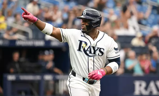 Tampa Bay Rays' Yandy Díaz celebrates as he rounds the bases after his two-run home run during the third inning of a baseball game against the Minnesota Twins Sunday, April 26, 2026, in St. Petersburg, Fla. (AP Photo/Jason Behnken)