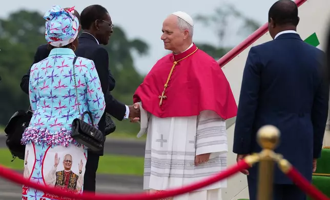 Pope Leo XIV is welcomed by Equatorial Guinea's President Teodoro Obiang Nguema Mbasogo, second left, upon his arrival at Malabo International Airport in Malabo, Equatorial Guinea, Tuesday, April 21, 2026, on the ninth day of his 11-day pastoral visit to Africa. (AP Photo/Misper Apawu)