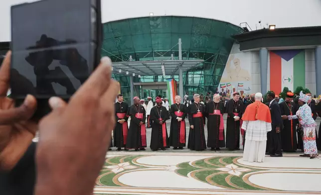 Pope Leo XIV is welcomed by Equatorial Guinea's President Teodoro Obiang Nguema Mbasogo, fifth from right, and his wife, second from right, Constancia Mangue de Obiang, upon his arrival at Malabo International Airport in Malabo, Equatorial Guinea, Tuesday, April 21, 2026, on the ninth day of his 11-day pastoral visit to Africa. (AP Photo/Andrew Medichini)