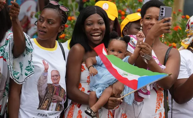 People wait for Pope Leo XIV in Malabo, Equatorial Guinea, Tuesday, April 21, 2026, on the ninth day of his 11-day pastoral visit to Africa. (AP Photo/Andrew Medichini)