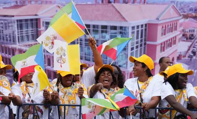 Faithful wait for the arrival of Pope Leo XIV at the airport in Malabo, Equatorial Guinea, Tuesday, April 21, 2026. (AP Photo/Misper Apawu)