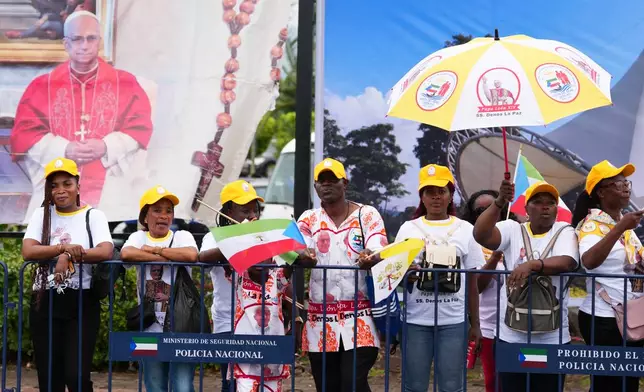 Faithful wait for the arrival of Pope Leo XIV at the airport in Malabo, Equatorial Guinea, Tuesday, April 21, 2026. (AP Photo/Misper Apawu)