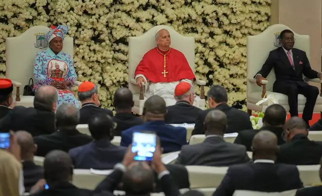 Pope Leo XIV, center, flanked by Equatorial Guinea's President Teodoro Obiang Nguema Mbasogo, left, President's wife Constancia Mangue, meets with the authorities, civil society and the diplomatic corps - epresentatives of the world of culture in Malabo, Equatorial Guinea, Tuesday, April 21, 2026, on the ninth day of his 11-day pastoral visit to Africa. (AP Photo/Andrew Medichini)