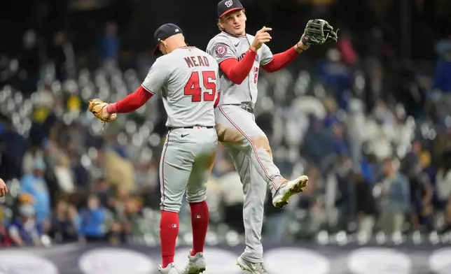 Washington Nationals first baseman Curtis Mead (45) and Brady House, right, react after winning a baseball game against the Milwaukee Brewers, Friday, April 10, 2026, in Milwaukee. (AP Photo/Kayla Wolf)