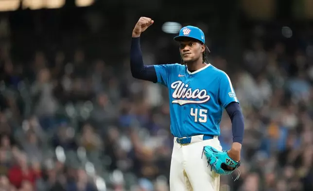 Milwaukee Brewers pitcher Abner Uribe reacts to a strikeout during the eighth inning of a baseball game against the Washington Nationals, Friday, April 10, 2026, in Milwaukee. (AP Photo/Kayla Wolf)