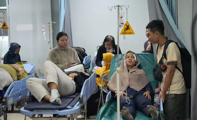 People who are injured in a train collision are treated at a hospital, in Bekasi, Indonesia, Tuesday, April 28, 2026. (AP Photo/Achmad Ibrahim)