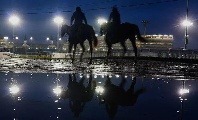 Horses head to the track for a workout at Churchill Downs Wednesday, April 29, 2026, in Louisville, Ky. (AP Photo/Charlie Riedel)