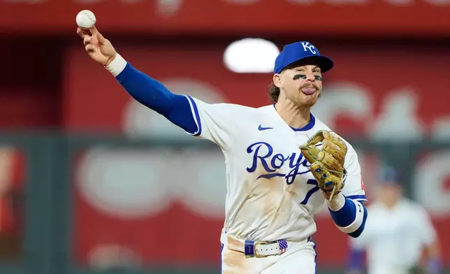 Kansas City Royals shortstop Bobby Witt Jr. throws to first for the double play hit into by Baltimore Orioles' Colton Cowser during the ninth inning of a baseball game Tuesday, April 21, 2026, in Kansas City, Mo. (AP Photo/Charlie Riedel)