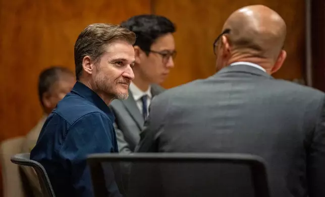 Defendant Gerhardt Konig, left, talks to his defense attorney Thomas Otake before closing arguments in his attempted murder trial, Tuesday, April 7, 2026, in Honolulu. (AP Photo/Mengshin Lin, Pool)