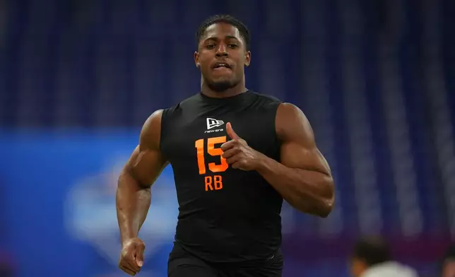 FILE - Notre Dame running back Jadarian Price (15) runs the 40-yard dash at the NFL football scouting combine in Indianapolis, on Feb. 28, 2026. (AP Photo/Julio Cortez, File)