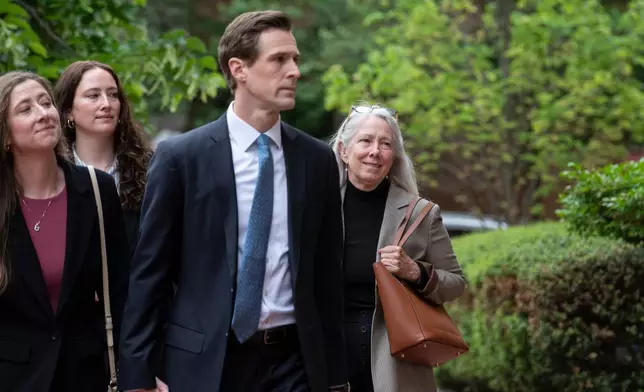 Patrice Failor, right, wife of former FBI Director James Comey, arrives, with family members, at the federal courthouse in Alexandria, Va., Wednesday, April 29, 2026. (AP Photo/Cliff Owen)