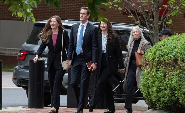 Patrice Failor, right, wife of former FBI Director James Comey, arrives, with family members, at the federal courthouse in Alexandria, Va., Wednesday, April 29, 2026. (AP Photo/Cliff Owen)