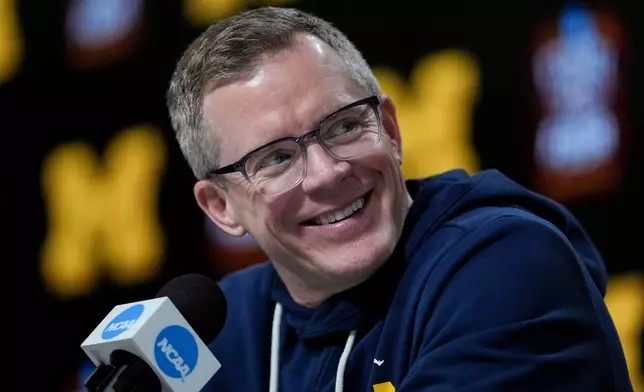 Michigan head coach Dusty May speaks during a news conference ahead of a national championship NCAA college basketball tournament game against UConn at the Final Four, Sunday, April 5, 2026, in Indianapolis. (AP Photo/Jeff Roberson)