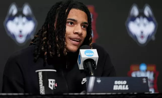 UConn guard Solo Ball speaks during a news conference ahead of a national championship NCAA college basketball tournament game against Michigan at the Final Four, Sunday, April 5, 2026, in Indianapolis. (AP Photo/Jeff Roberson)