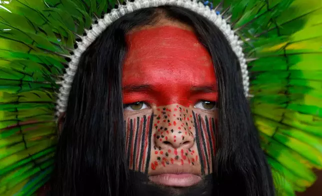 A Pataxo man looks on before a march at the Acampamento Terra Livre 2026, an Indigenous mobilization focused on land rights and environmental protection, in Brasilia, Brazil, Thursday, April 9, 2026. (AP Photo/Eraldo Peres)