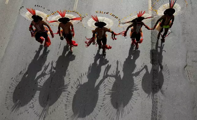 Karaja people take part in a march at the Acampamento Terra Livre 2026, an Indigenous mobilization focused on land rights and environmental protection, in Brasilia, Brazil, Thursday, April 9, 2026. (AP Photo/Eraldo Peres)