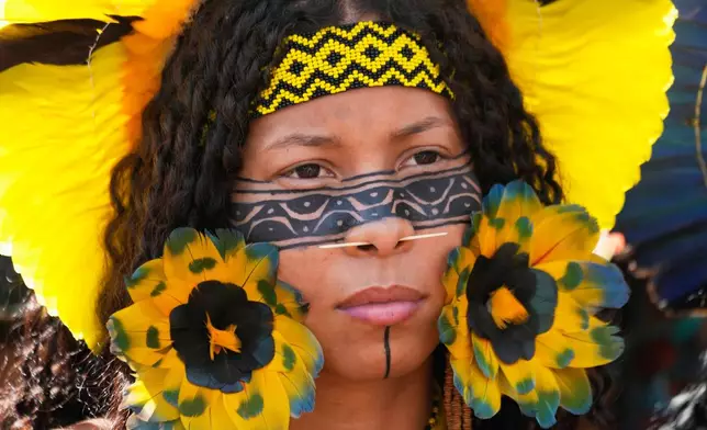 A Xakriaba Indigenous woman attends a march during the annual "Acampamento Terra Livre," or Free Land Encampment, Brazil's largest annual Indigenous mobilization that focuses on land rights and environmental protection, in Brasilia, Brazil, Tuesday, April 7, 2026. (AP Photo/Eraldo Peres)