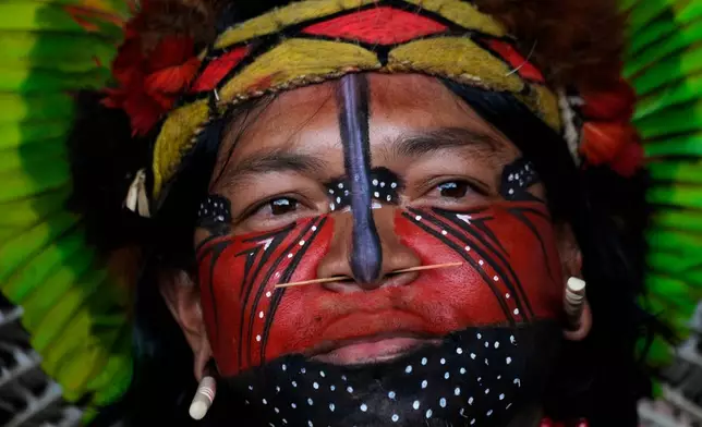 A Pataxo man looks on before a march at the Acampamento Terra Livre 2026, an Indigenous mobilization focused on land rights and environmental protection, in Brasilia, Brazil, Thursday, April 9, 2026. (AP Photo/Eraldo Peres)