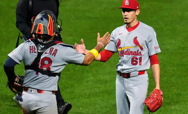 St. Louis Cardinals pitcher Riley O'Brien (61) celebrates with catcher Iván Herrera after getting the final out of a baseball game against the Pittsburgh Pirates in Pittsburgh, Wednesday, April 29, 2026. (AP Photo/Gene J. Puskar)