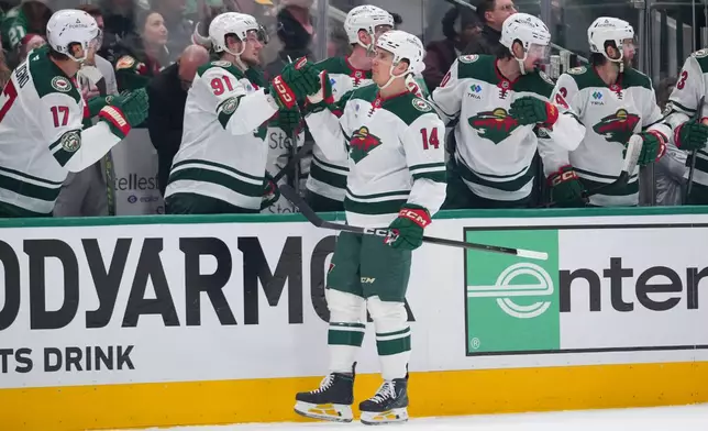 Minnesota Wild center Joel Eriksson Ek (14) skates by his bench after scoring a power play goal against the Dallas Stars during the first period in Game 1 of a first-round NHL Stanley Cup playoffs hockey series, Saturday, April 18, 2026, in Dallas, Texas. (AP Photo/Julio Cortez)