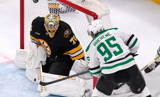 Dallas Stars center Matt Duchene, right, scores against Boston Bruins goaltender Joonas Korpisalo (70) during the second period of an NHL hockey game, Tuesday, March 31, 2026, in Boston. (AP Photo/Charles Krupa)