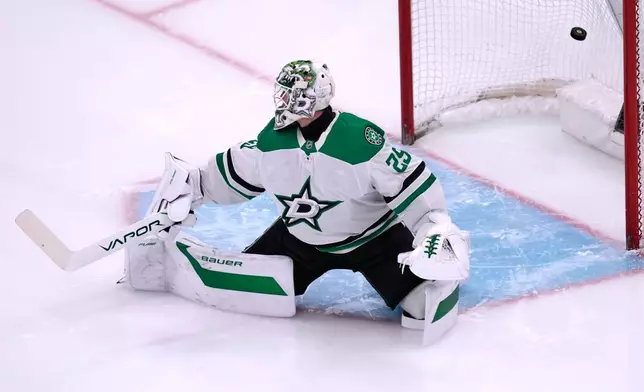 Dallas Stars goaltender Jake Oettinger (29) looks back at the puck on a goal by Boston Bruins center Elias Lindholm during the third period of an NHL hockey game, Tuesday, March 31, 2026, in Boston. (AP Photo/Charles Krupa)
