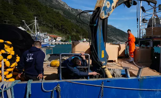 Fishermen prepare to depart for fishing in the port of Plomin, Croatia, Monday, April 6, 2026. (AP Photo/Darko Bandic)
