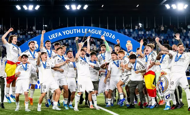 Real Madrid's players celebrate with the trophy after winning the Youth League final soccer match between Club Brugge and Real Madrid in Lausanne, Switzerland, Monday, April 20, 2026. (Jean-Christophe Bott/Keystone via AP)