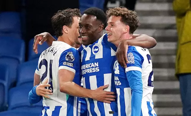 Brighton and Hove Albion's Danny Welbeck, center, celebrates scoring their third goal during the Premier League soccer match between Brighton and Hove Albion and Chelsea, Tuesday, April 21 2026, in Brighton, England. (Gareth Fuller/PA via AP)