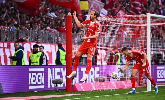 Bayern's Harry Kane celebrates after scoring a goal during a Bundesliga soccer match between Bayern and Stuttgart in Munich, Germany, Sunday, April 19, 2026. (Tom Weller/dpa via AP)