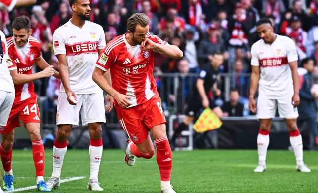 Bayern's Harry Kane celebrates after scoring a goal during a Bundesliga soccer match between Bayern and Stuttgart in Munich, Germany, Sunday, April 19, 2026. (Tom Weller/dpa via AP)