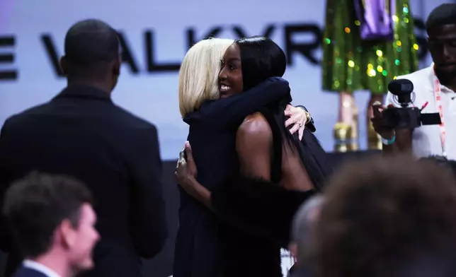 LSU guard Flau'jae Johnson hugs LSU coach Kim Mulkey after being selected eighth overall by the Golden State Valkyries in the first round of the WNBA basketball draft Monday, April 13, 2026, in New York. (AP Photo/Pamela Smith)