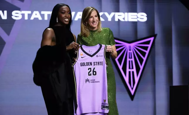 LSU guard Flau'jae Johnson poses with WNBA commissioner Cathy Engelbert after being selected eighth overall by the Golden State Valkyries in the first round of the WNBA basketball draft Monday, April 13, 2026, in New York. (AP Photo/Pamela Smith)