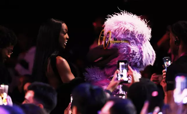 LSU guard Flau'jae Johnson walks to the stage after being selected eighth overall by the Golden State Valkyries in the first round of the WNBA basketball draft Monday, April 13, 2026, in New York. (AP Photo/Pamela Smith)