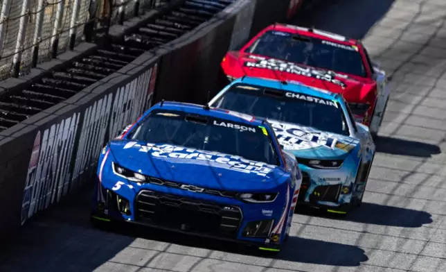 Kyle Larson (5) leads Ross Chastain during a NASCAR Cup Series auto race, Sunday, April 12, 2026, in Bristol, Tenn. (AP Photo/Wade Payne)