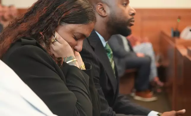 The mother of Casey Goodson Jr., Tamala Payne, covers her ears during opening statements in the retrial offormer Franklin County Deputy Jason Meade, who is charged with murder and reckless homicide in the 2020 killing of Goodson Jr., inside Franklin County Common Pleas Court in Columbus, Ohio, Thursday, April 23, 2026. (Doral Chenoweth/Pool Photo via AP)