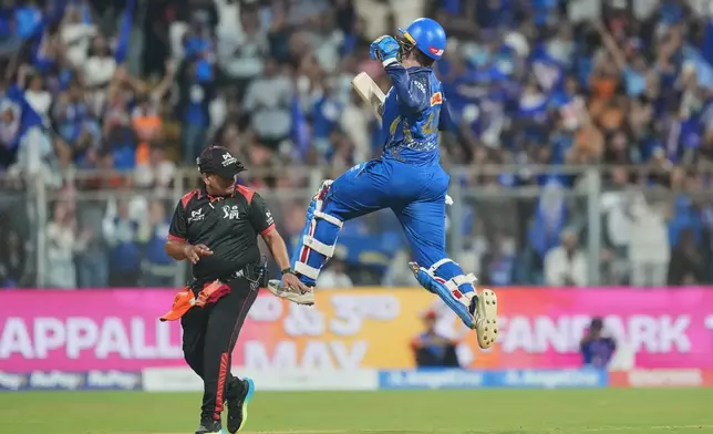 Mumbai Indians' Ryan Rickelton jumps in air as he celebrates after scoring a century during the Indian Premier League cricket match between Mumbai Indians and Sunrisers Hyderabad in Mumbai, India, Wednesday, April 29, 2026.(AP Photo/Rafiq Maqbool)