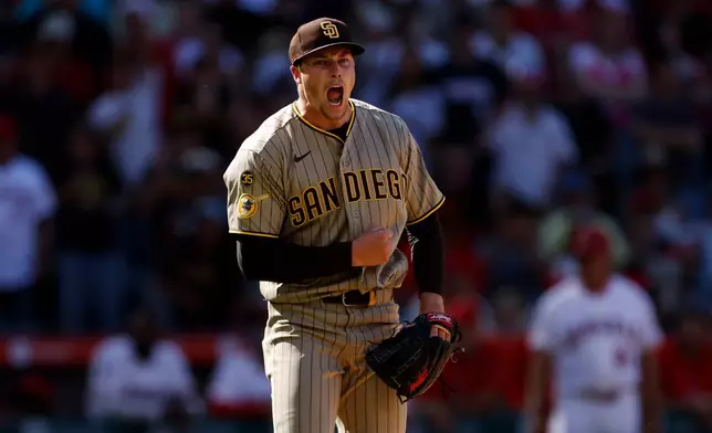 San Diego Padres relief pitcher Mason Miller (22) reacts upon striking out the last batter to defeat the Los Angeles Angels at the end of the ninth inning of a baseball game, Sunday, April 19, 2026, in Anaheim, Calif. (AP Photo/Caroline Brehman)