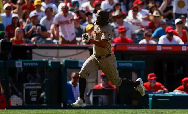 San Diego Padres' Xander Bogaerts (2) runs to home plate to score during the seventh inning of a baseball game against the Los Angeles Angels, Sunday, April 19, 2026, in Anaheim, Calif. (AP Photo/Caroline Brehman)