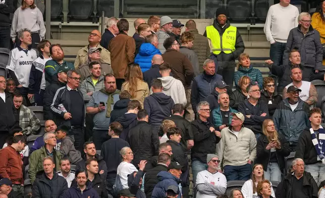 Tottenham fans leave the stadium after their team conceded a third goal during the English Premier League soccer match between Tottenham Hotspur and Nottingham Forest in London, Sunday, March 22, 2026. (AP Photo/Dave Shopland)