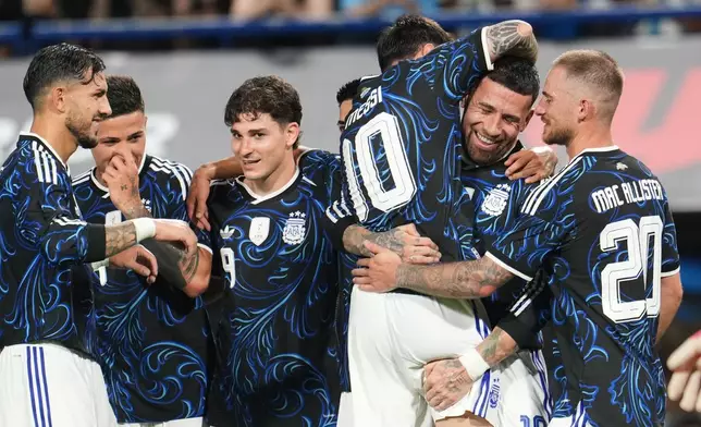 Temmates congratulate Argentina's Nicolas Otamendi after he scored his side's third goal against Zambia during a friendly soccer match in Buenos AIres, Argentina, Tuesday, March 31, 2026. (AP Photo/Rodrigo Abd)