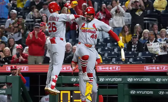 St. Louis Cardinals' JJ Wetherholt (26) celebrates with Iván Herrera (48) on his way back to the dugout after his home run off of Pittsburgh Pirates pitcher Dennis Santana in the ninth inning of a baseball game, in Pittsburgh, Monday, April 27, 2026. (AP Photo/Tom E. Puskar)