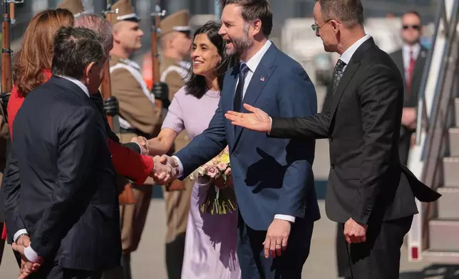Hungarian Foreign Minister Peter Szijjarto, right, welcomes U.S. Vice President JD Vance, center right, and second lady Usha Vance, center left, as they arrive at Budapest Ferenc Liszt International Airport in Budapest, Hungary Tuesday, April 7, 2026. (Jonathan Ernst/Pool Photo via AP)