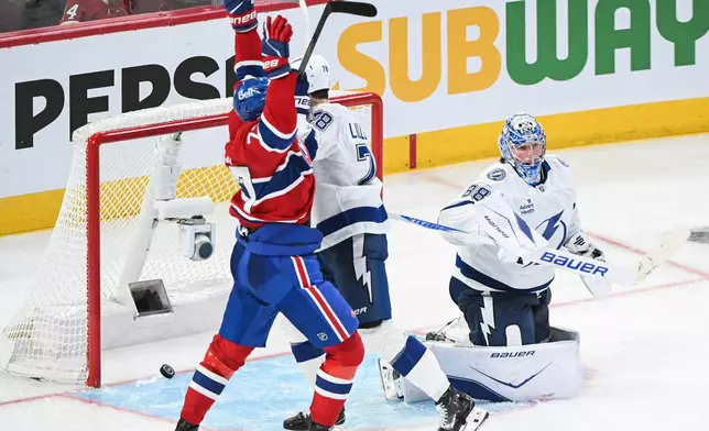 Montreal Canadiens' Kirby Dach (77) reacts to a goal by teammate Lane Hutson against Tampa Bay Lightning goaltender Andrei Vasilevskiy (88) during overtime in an NHL hockey playoff game in Montreal, Friday, April 24, 2026. (Graham Hughes/The Canadian Press via AP)