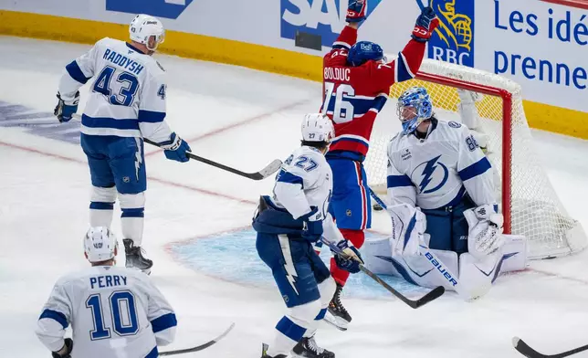 Montreal Canadiens' Zachary Bolduc (76) celebrates after a goal by teammate Kirby Dach (not shown) against Tampa Bay Lightning goaltender Andrei Vasilevskiy, right, during the second period of Game 3 in a first-round NHL hockey Stanley Cup playoff series in Montreal, Friday, April 24, 2026. (Christinne Muschi/The Canadian Press via AP)