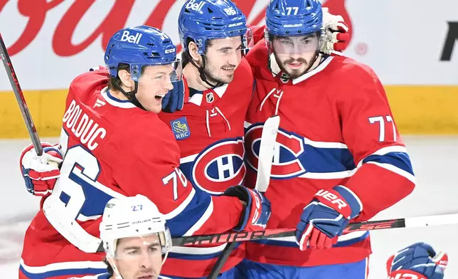 Montreal Canadiens' Kirby Dach (77) celebrates with teammates Zachary Bolduc (76) and Alexandre Texier (85) after scoring against the Tampa Bay Lightning during the second period of Game 3 in a first-round NHL hockey Stanley Cup playoff series in Montreal, Friday, April 24, 2026. (Graham Hughes/The Canadian Press via AP)