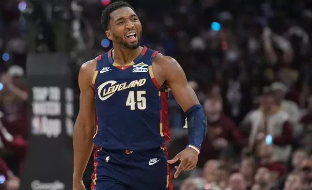 Cleveland Cavaliers guard Donovan Mitchell (45) gestures to the crowd in the first half in Game 2 of a first-round NBA basketball playoffs series against the Toronto Raptors in Cleveland, Monday, April 20, 2026. (AP Photo/Sue Ogrocki)