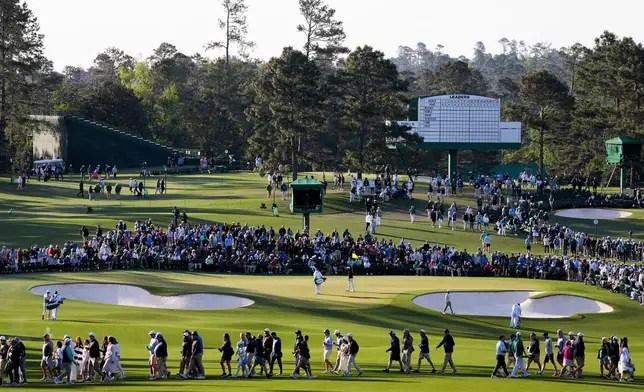 Fans walk on the second hole during the first round of the Masters golf tournament at the Augusta National Golf Club, Thursday, April 9, 2026, in Augusta, Ga. (AP Photo/Ashley Landis)