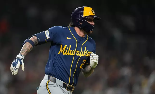 Milwaukee Brewers' Brice Turang runs out a one-run single against the Detroit Tigers during the seventh inning of a baseball game Tuesday, April 21, 2026, in Detroit. (AP Photo/Paul Sancya)