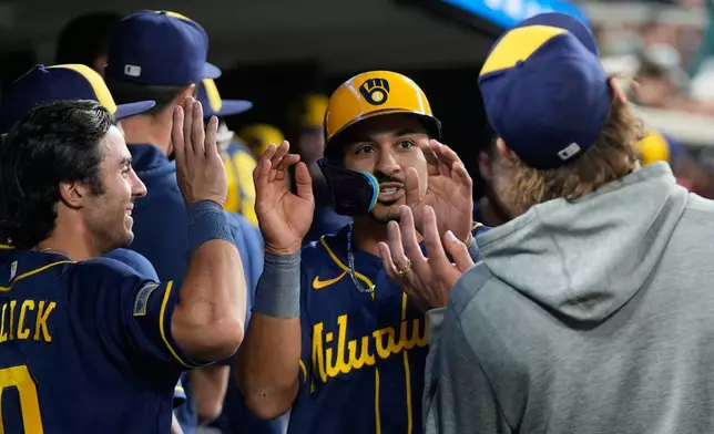 Milwaukee Brewers' David Hamilton (6) celebrates scoring against the Detroit Tigers during the seventh inning of a baseball game Tuesday, April 21, 2026, in Detroit. (AP Photo/Paul Sancya)